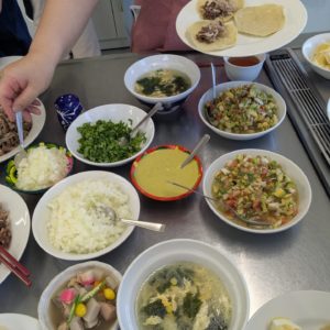 トマトや玉ねぎなどの野菜をみじん切りにして作ったピコデガヨや新潟の郷土料理のっぺが盛り付けられているテーブルの様子