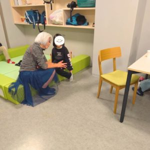 ネオアス村地域食堂にボランティアで来てくれた、中学校講師のあつこ先生と勉強や話ををする小学生の女の子の様子